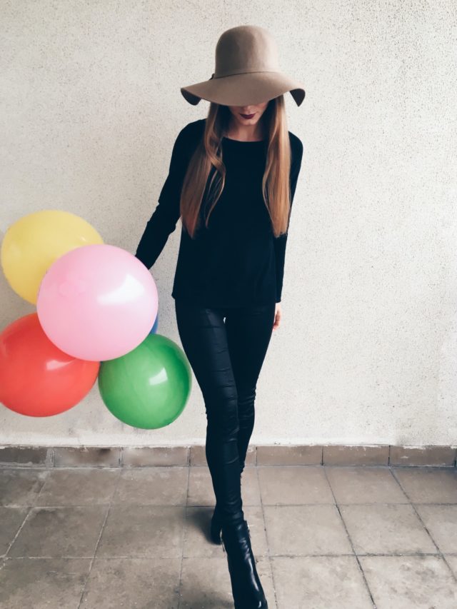 cropped-a-girl-in-the-black-leather-leggings-and-modern-stylish-hat-with-colorful-ballons.jpg