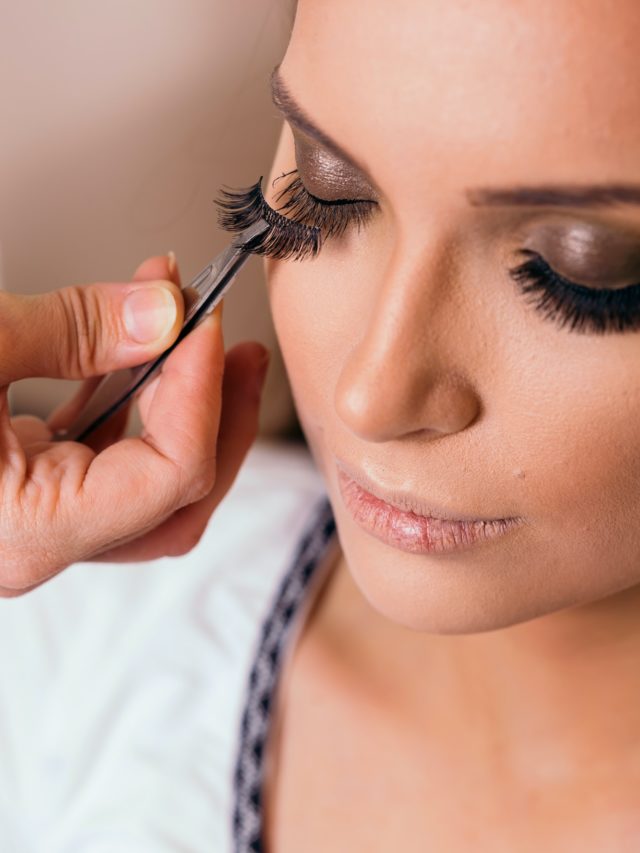 Make up artist putting artificial eyelashes